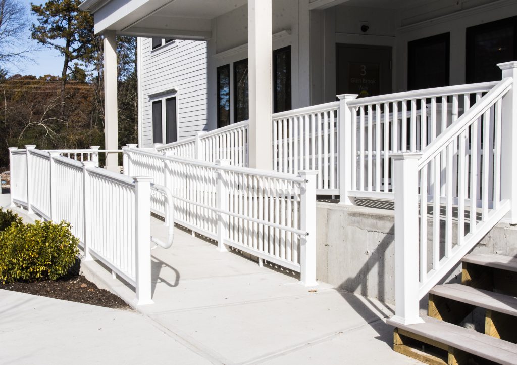 Long ramp going into building of affordable apartments, with some accessible units.