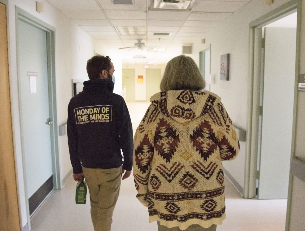 zach and his mother, terry walking in nursing home halls.  Walls are white, no decorations.
